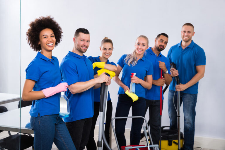 portrait,of,happy,male,and,female,janitors,with,cleaning,equipment